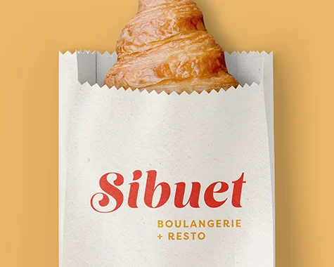 Rendu d'un emballage de croissant avec le logo de la boulangerie Sibuet